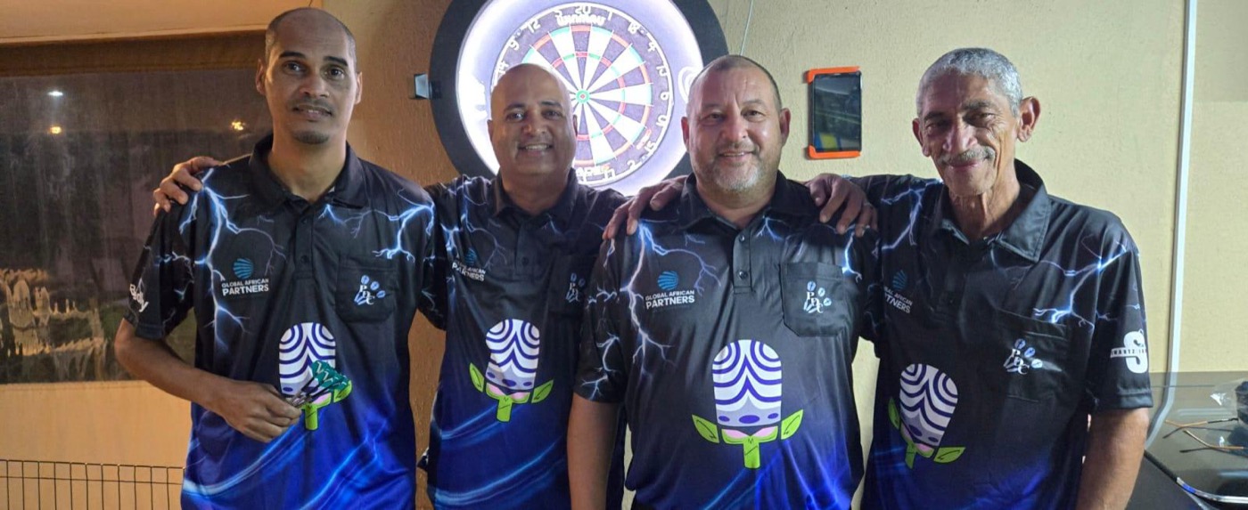 Four club players standing in front of a dartboard in club shirts